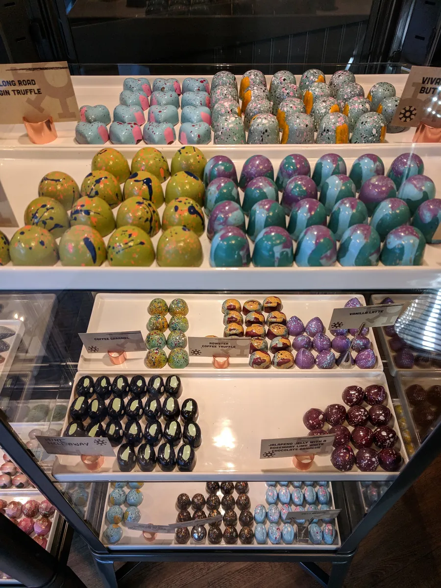 Rows of vivid hand-painted cocoa-butter bonbons in Mokaya's case.