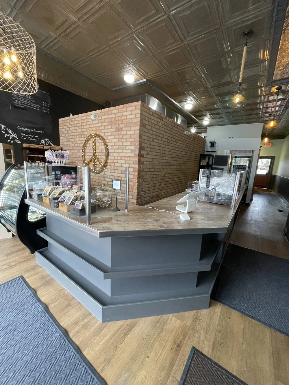 Mokaya's warm interior with brick, a pressed-tin ceiling and a gold peace sign.