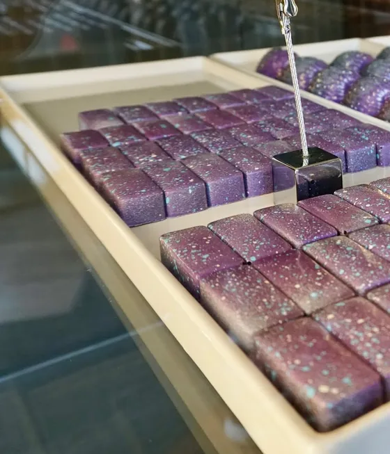 Purple galaxy-speckled Vanilla Latte bonbon squares.